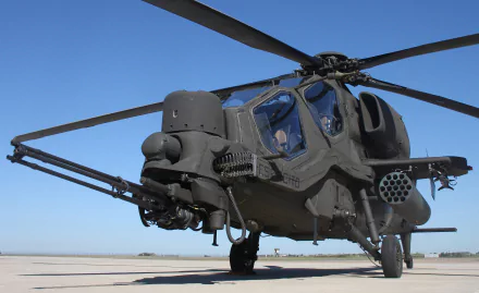 Close-up of an Agusta A129 Mangusta military attack helicopter on the ground against a clear blue sky, captured in HD for desktop wallpaper use.