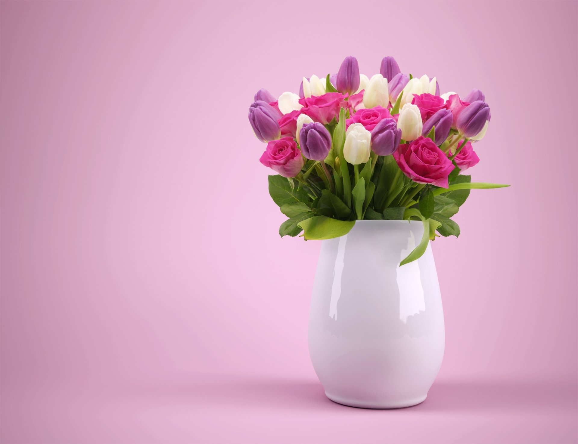A vibrant bouquet of pink, purple, and white tulips in a white vase against a soft pink background, designed as an HD PC desktop wallpaper and background.