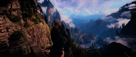 Geralt of Rivia from The Witcher 3: Wild Hunt stands on a cliff overlooking a vast, mountainous fantasy landscape in this HD PC desktop wallpaper.