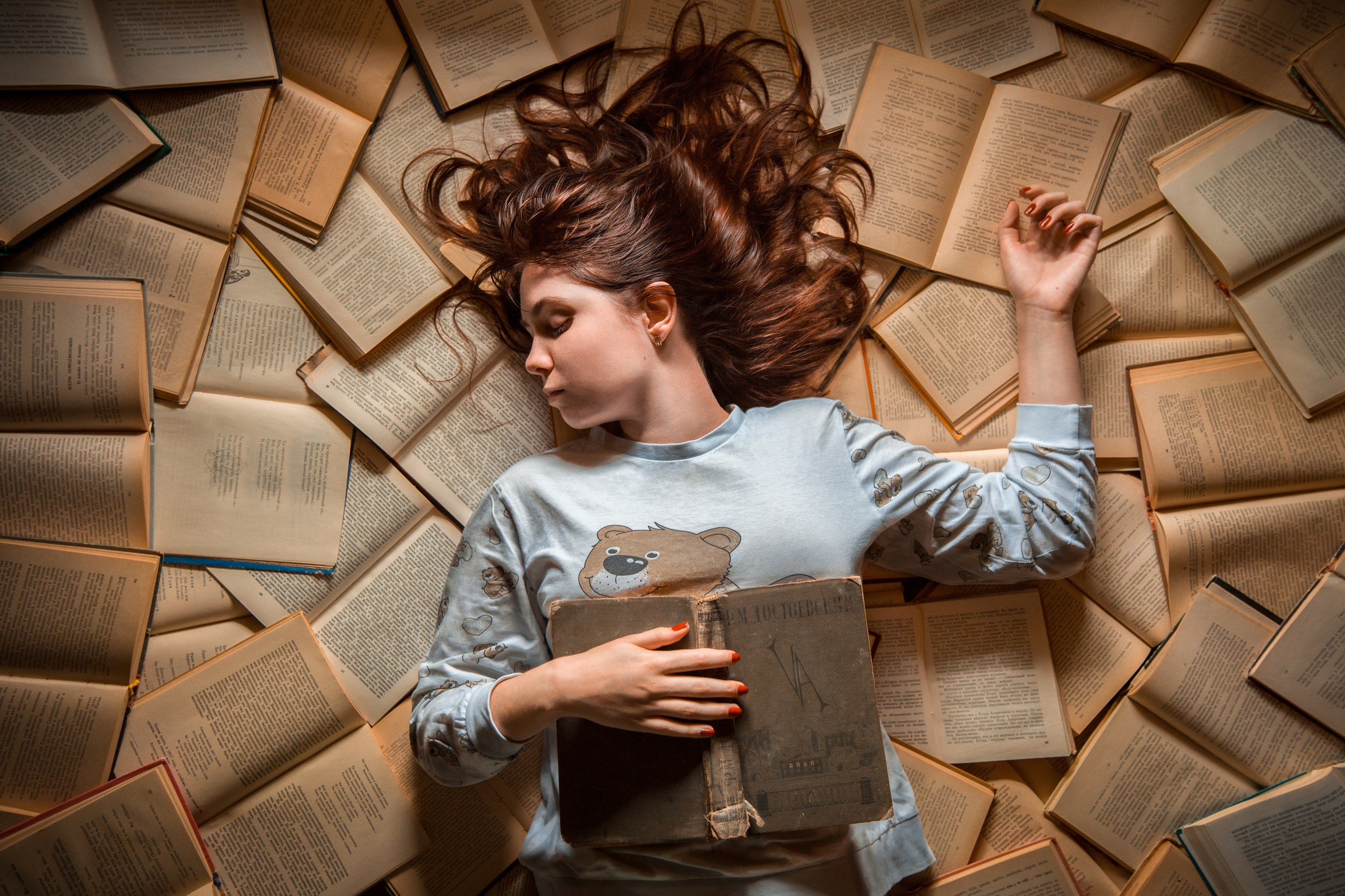 Girl sleeping on books by Andrew Vasiliev