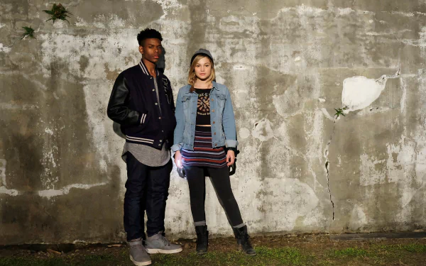 HD wallpaper featuring two characters from Cloak & Dagger standing against a concrete wall.