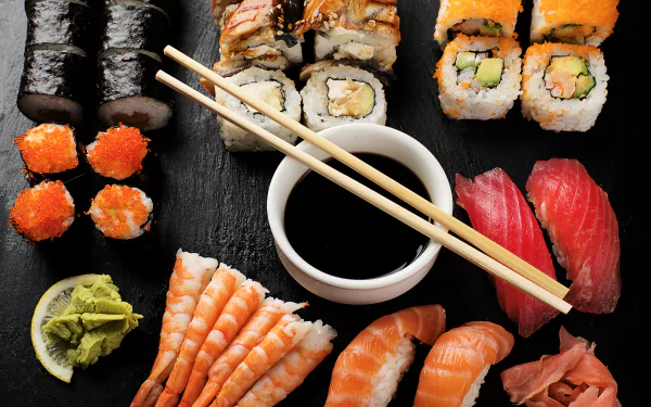 A vibrant 4K Ultra HD wallpaper featuring an assortment of sushi, seafood, rice, and wasabi with chopsticks resting over a soy sauce dish on a dark background.