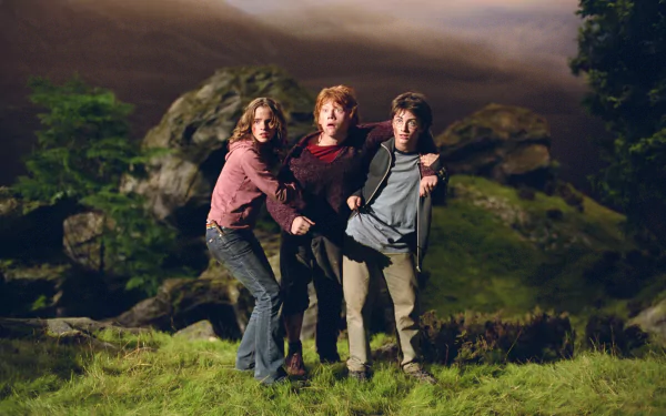 HD desktop wallpaper featuring Harry Potter, Ron Weasley, and Hermione Granger from the movie Harry Potter and the Prisoner of Azkaban standing together in a dark, rocky landscape.