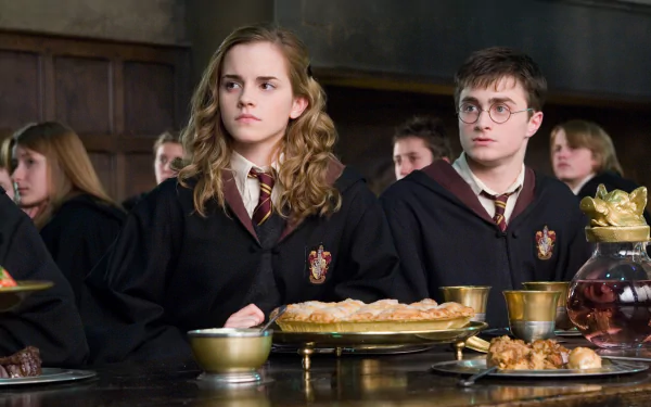 HD desktop wallpaper featuring Hermione Granger and Harry Potter from the movie Harry Potter and the Order of the Phoenix, both in Gryffindor robes at the Hogwarts dining hall.