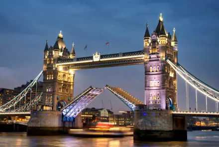 Tower Bridge over the Thames in London, England, illuminated at night, captured in stunning 4K Ultra HD as a man-made architectural icon of the United Kingdom.