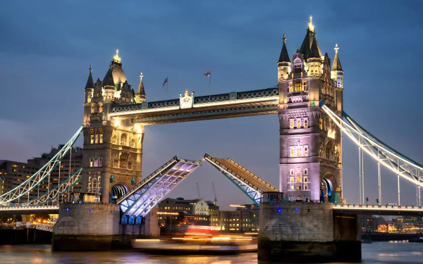 Tower Bridge over the Thames in London, England, illuminated at night, captured in stunning 4K Ultra HD as a man-made architectural icon of the United Kingdom.