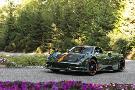 A green Pagani Huayra Roadster BC supercar parked on a scenic road surrounded by greenery, captured as an HD PC desktop wallpaper and background.