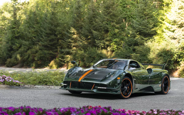 A green Pagani Huayra Roadster BC supercar parked on a scenic road surrounded by greenery, captured as an HD PC desktop wallpaper and background.