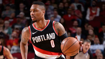 HD desktop wallpaper featuring Damian Lillard in action, wearing a Portland Trail Blazers jersey, dribbling a basketball.