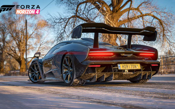 HD desktop wallpaper of Forza Horizon 4, featuring a sleek car on a wintry road with bare trees in the background. The game's logo is visible in the top left corner.