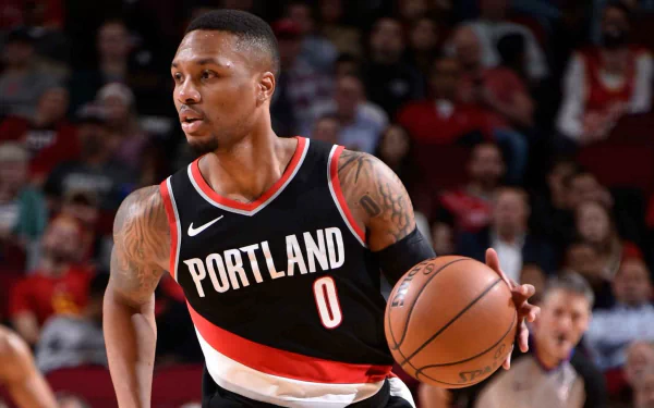 HD desktop wallpaper featuring Damian Lillard in action, wearing a Portland Trail Blazers jersey, dribbling a basketball.