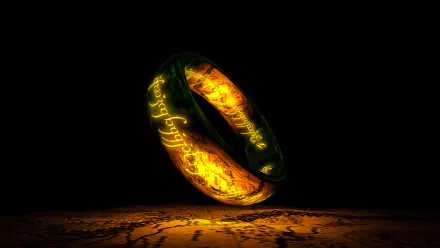 HD desktop wallpaper featuring a glowing ring from The Lord of the Rings, engraved with Elvish script, floating above a textured background.