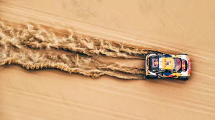 A 4K Ultra HD desktop wallpaper showing a rally race car kicking up sand as it speeds through a desert landscape.