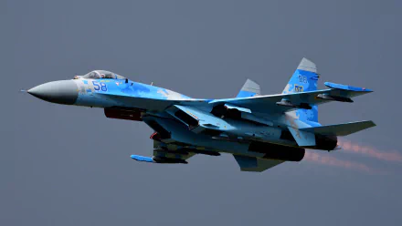 Ukrainian Air Force Sukhoi Su-27 jet fighter in flight, captured in high-definition as a military warplane against a clear sky.