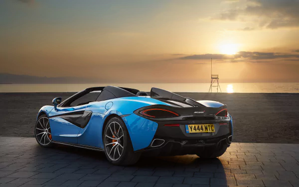 Blue McLaren 570S supercar parked on a coastal road at sunset, captured in 4K Ultra HD for a striking PC desktop wallpaper and background.