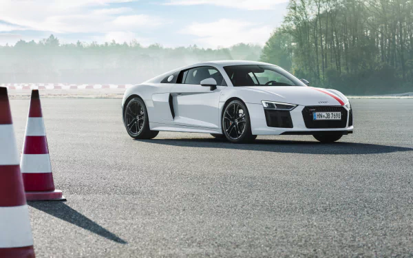 White Audi R8 V10 on an asphalt course near cones with a misty treeline — 4K Ultra HD PC desktop wallpaper.