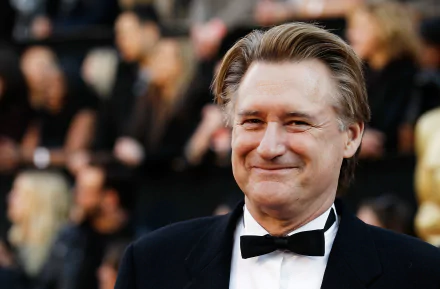 HD desktop wallpaper featuring a smiling man in a tuxedo at an elegant event.