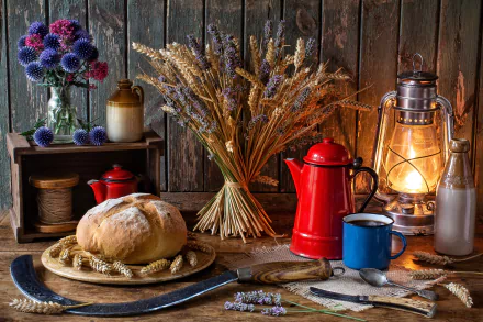 A serene still life HD desktop wallpaper featuring a loaf of bread, a red coffee pot, a blue mug, a lantern, and rustic elements like a bottle, spoon, knife, vase with flowers, and wheat stalks.