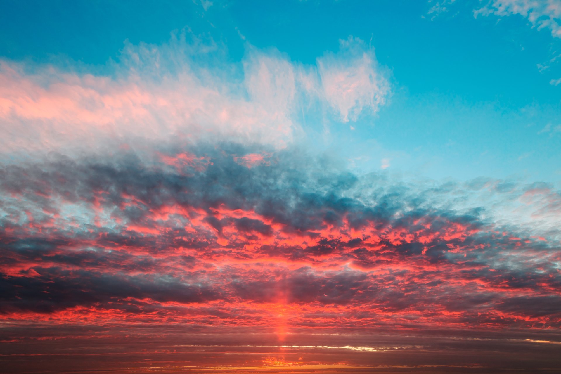 A vibrant sunrise over the ocean horizon with colorful clouds and a bright sky, captured in stunning 4K Ultra HD clarity for a PC desktop background.