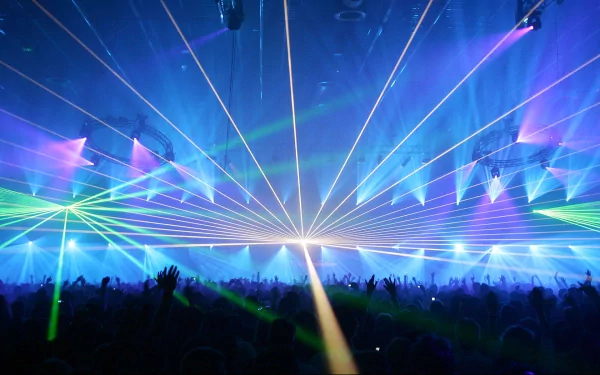 A vibrant HD desktop wallpaper featuring a lively dance scene filled with colorful laser lights and an energetic crowd, capturing the essence of music and movement.