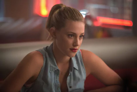 HD desktop wallpaper featuring Lili Reinhart from the TV show Riverdale in a softly lit, casual scene.