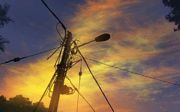 Anime-style HD PC desktop wallpaper featuring a vibrant sky with colorful clouds at sunset, framed by silhouetted trees and an electric pole with wires.