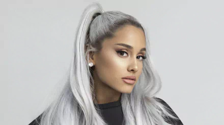 Ariana Grande with long white hair styled in a high ponytail, wearing earrings, showcasing her brown eyes in a 4K Ultra HD portrait.