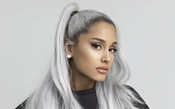 Ariana Grande with long white hair styled in a high ponytail, wearing earrings, showcasing her brown eyes in a 4K Ultra HD portrait.