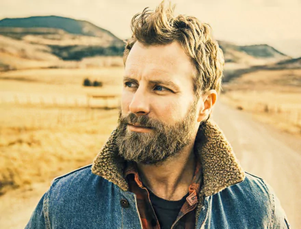 HD desktop wallpaper featuring a thoughtful man in a rural setting with a road stretching behind him.