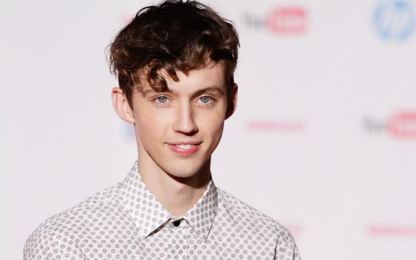 HD wallpaper featuring a person with a patterned shirt posing for the camera, providing a polished background for desktops.