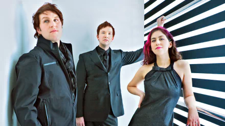 HD desktop wallpaper featuring the band Freezepop posing in front of a black-and-white striped background.