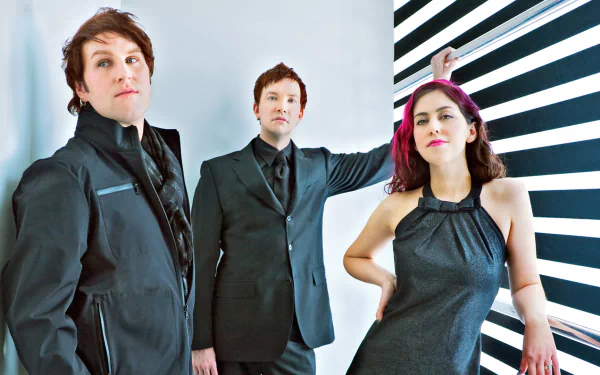 HD desktop wallpaper featuring the band Freezepop posing in front of a black-and-white striped background.