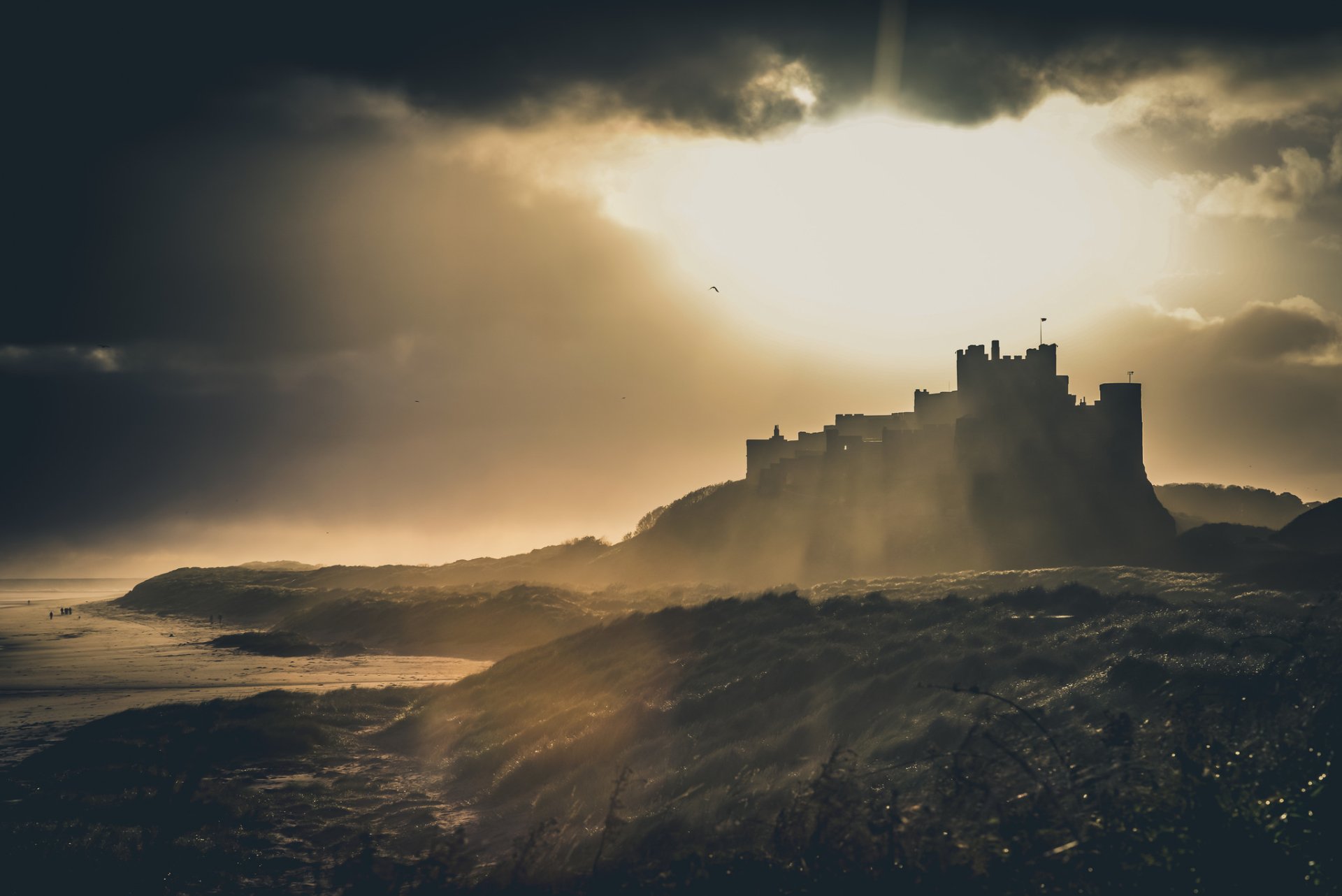 HD desktop wallpaper showcasing an old, man-made castle silhouetted against a dramatic, cloudy sky at dawn or dusk.
