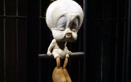HD wallpaper featuring Tweety from the Looney Tunes TV show, showcasing the iconic character in a playful pose, set against a dark, cage-like background.