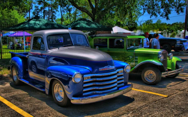 A vibrant HDR image featuring classic Chevrolet vehicles, showcasing a blue pickup truck and a green vintage car, set against a bright outdoor backdrop.