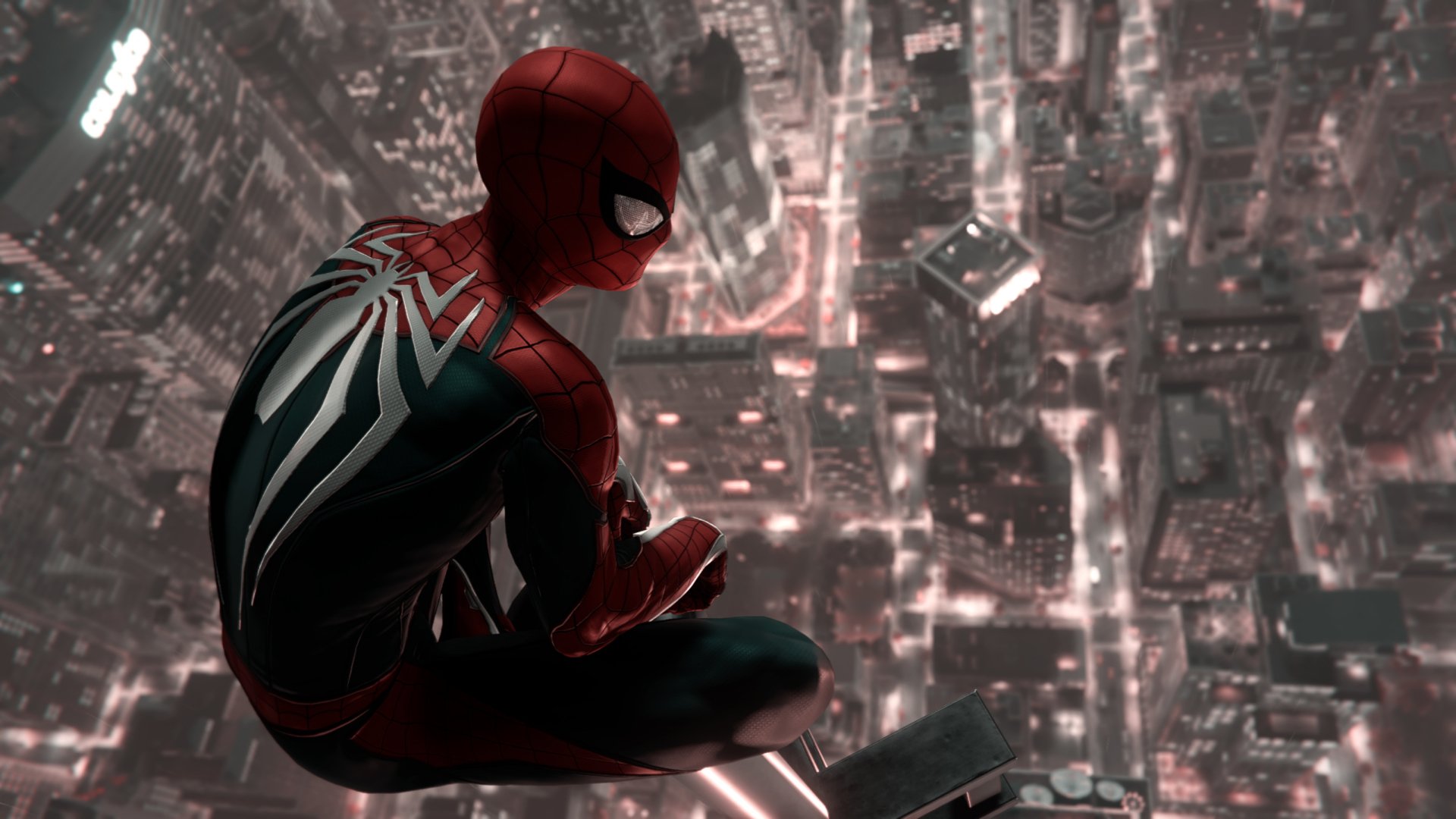 Spider-Man from the Spider-Man (PS4) video game perches above a glowing cityscape in this HD PC desktop wallpaper and background.