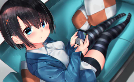 Anime girl with short black hair, blue eyes, and a blush, dressed in a blue jacket, holding a phone while sitting on a couch. HD desktop wallpaper and background.