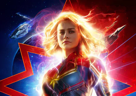 HD desktop wallpaper featuring Brie Larson as Captain Marvel, with her glowing in front of a cosmic background and star-shaped logo, two spaceships flying nearby.