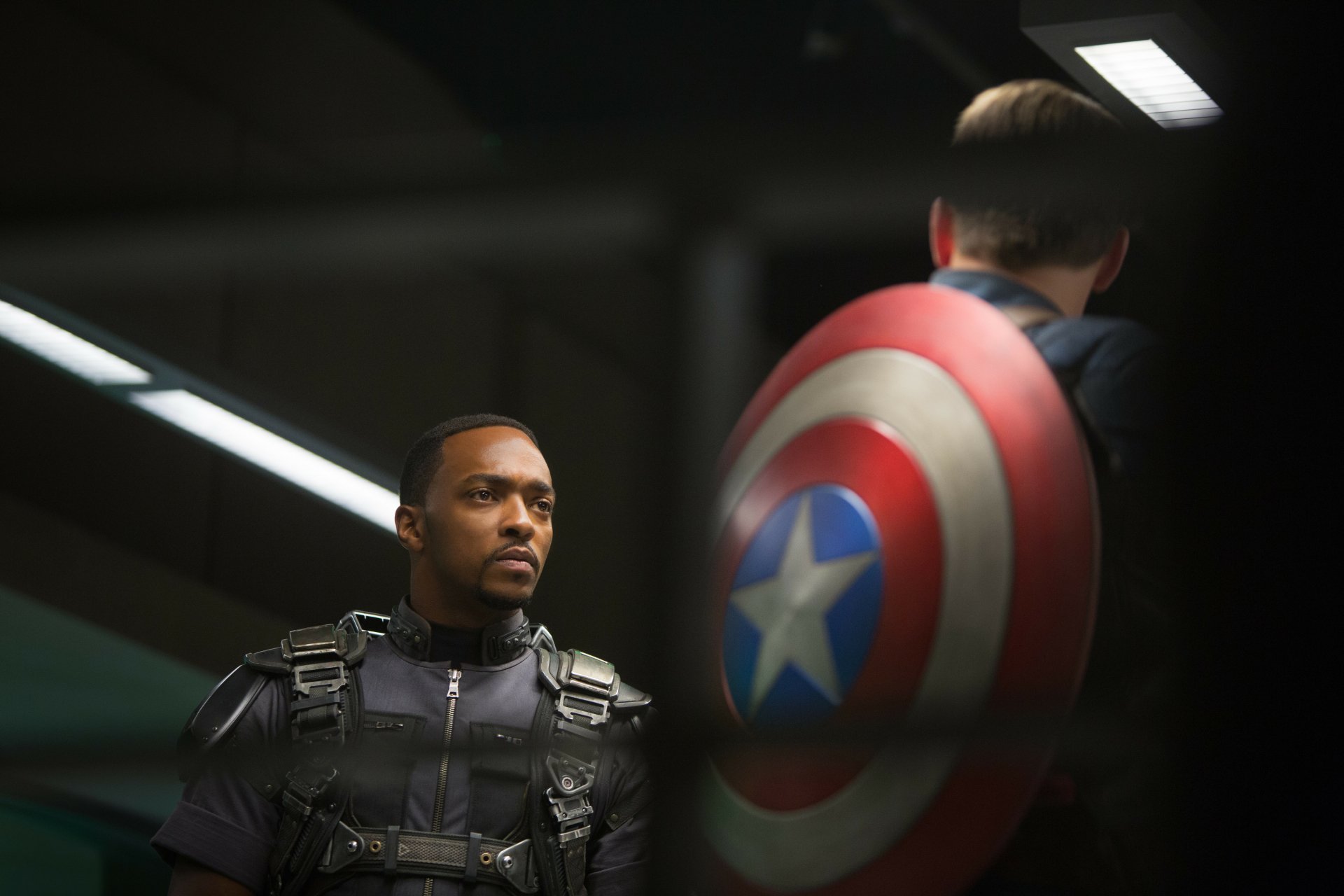 Falcon stands in tactical gear alongside Captain America with his iconic shield in this 4K Ultra HD wallpaper from the movie Captain America: The Winter Soldier.