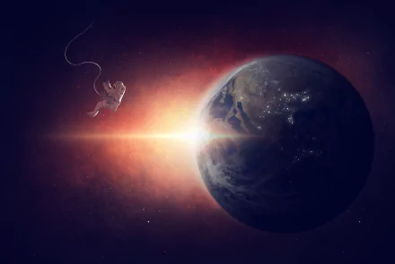 5K Ultra HD PC desktop wallpaper: Sci‑Fi scene of an astronaut drifting in space beside a glowing planet with city lights, a bright solar flare casting an orange halo.