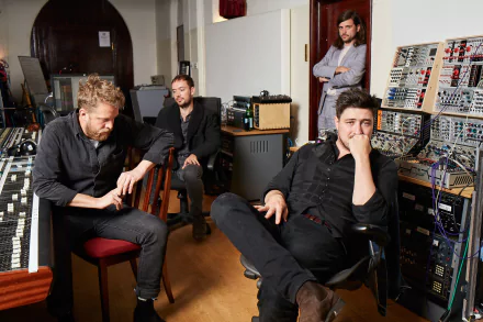 Mumford & Sons band members sitting pensively in a recording studio, ideal HD desktop wallpaper and background.