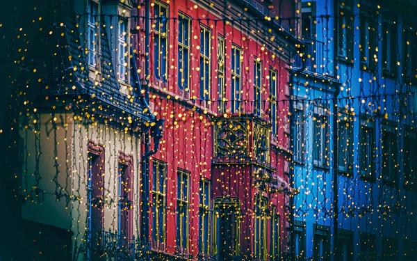 HD desktop wallpaper of a rain-soaked city street with twinkling lights reflecting off buildings.
