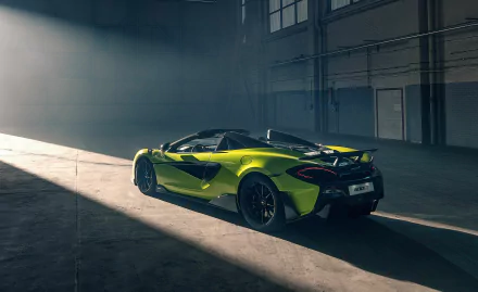 Green McLaren 600LT supercar parked in an industrial garage, presented as a 5K Ultra HD PC desktop wallpaper background.