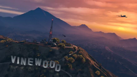 HD PC desktop wallpaper featuring the Vinewood sign and a sunset landscape from the video game Grand Theft Auto V.