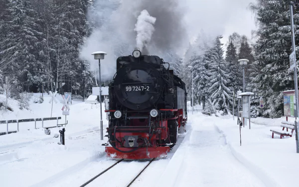 A steam locomotive travels through a snowy winter landscape, captured in 4K Ultra HD detail as a striking PC desktop wallpaper.