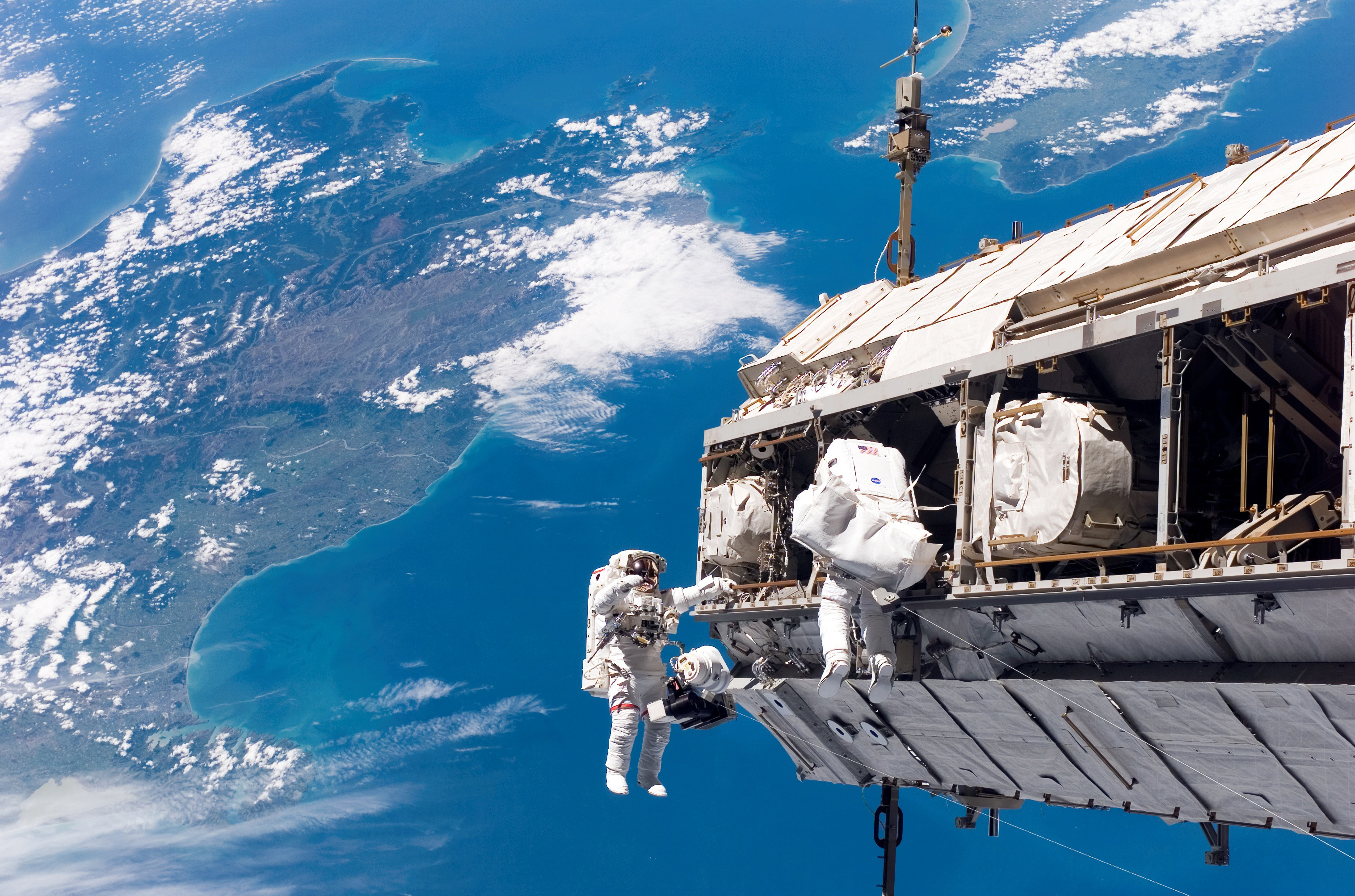 Astronaut floating over Earth in outer space.