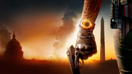 HD desktop wallpaper from Tom Clancy's The Division 2, featuring a close-up of a character's arm holding a gun against a backdrop of iconic Washington D.C. landmarks at sunset.