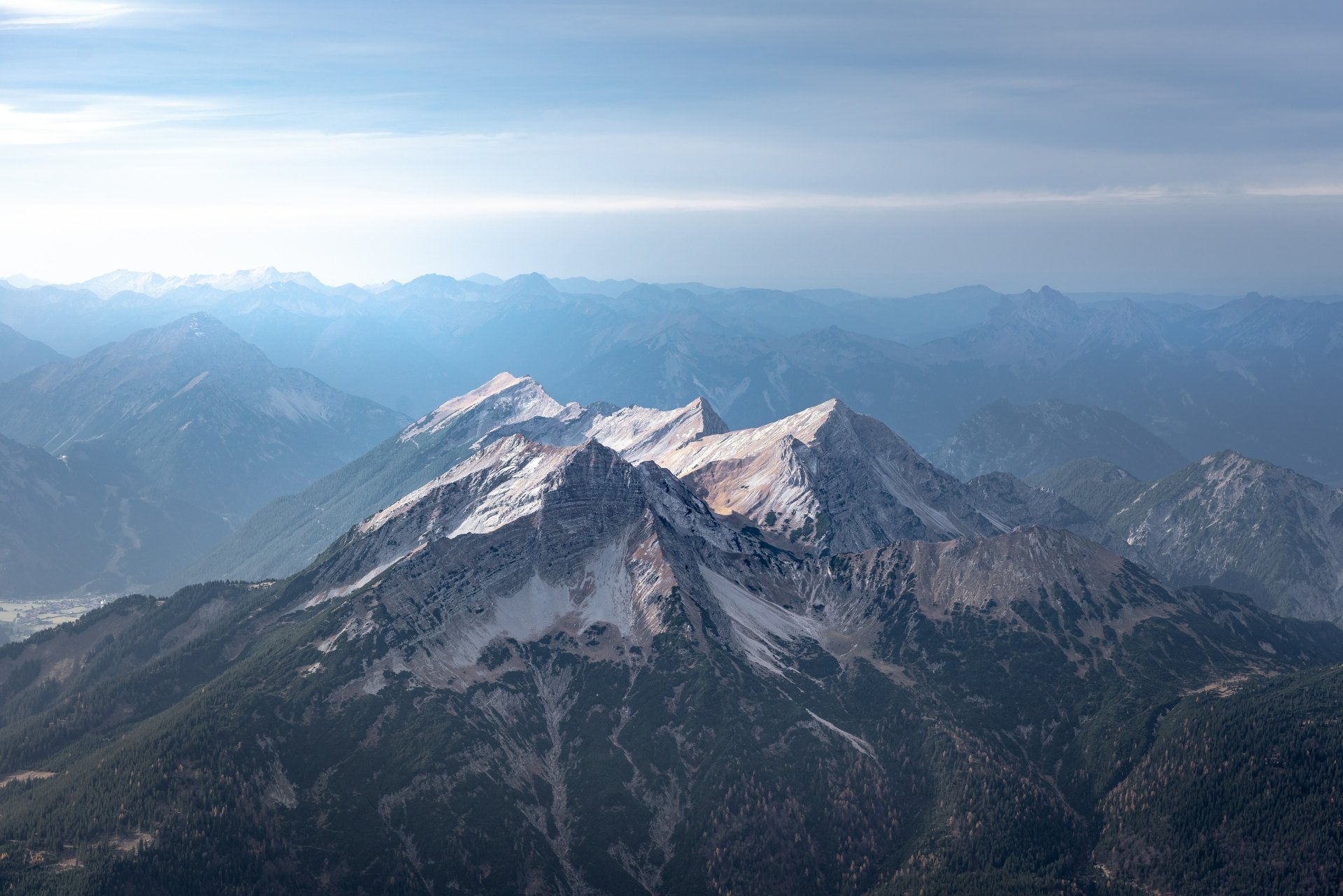 A stunning 4K Ultra HD desktop wallpaper featuring rugged mountain peaks under a vast, clear sky showcasing the beauty of nature.