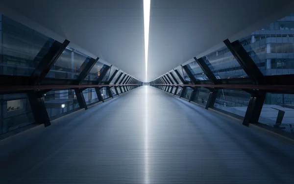 A 4K Ultra HD man-made skyway with sleek glass railings and a bright, narrow light strip running along the ceiling, creating a futuristic corridor effect.