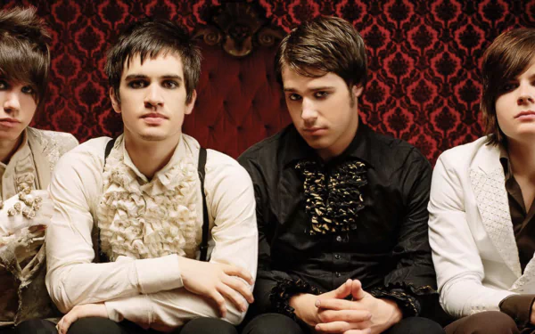 HD desktop wallpaper of Panic! at the Disco band members posing against a red patterned background.